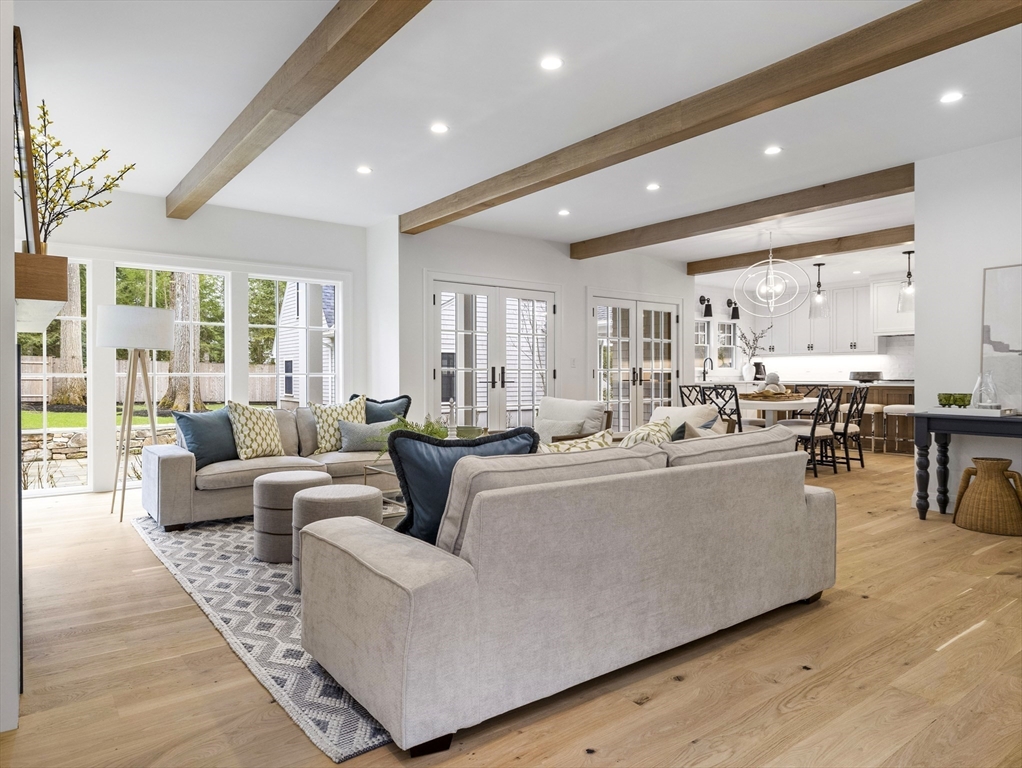 77 Forest Street Wellesley, MA 02481 - Photo 7 of 32 a living room with couches and kitchen view with wooden floor