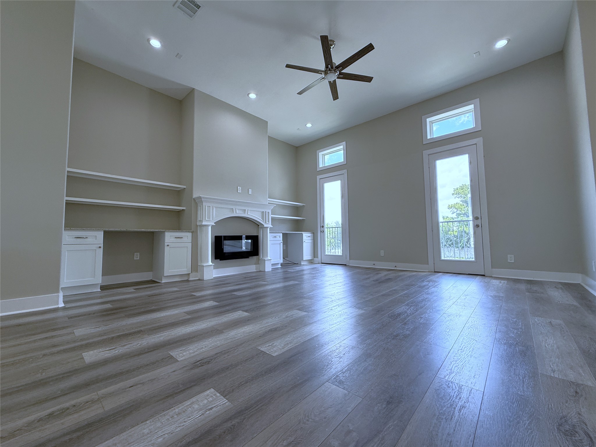 2123 Bidwell Drive Houston, TX 77018 - Photo 15 of 29 an empty room with wooden floor fireplace and windows