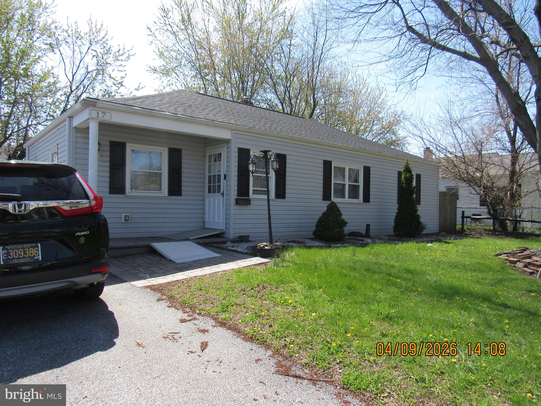 a view of a house with a backyard and trees