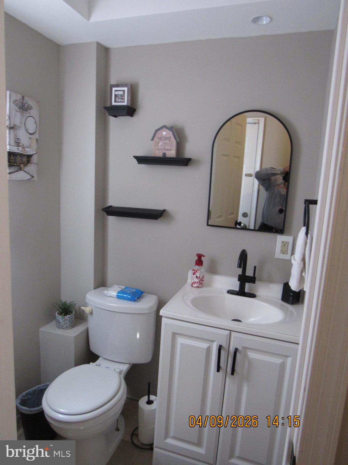 17 Lea Road New Castle, DE 19720 - Photo 11 of 17 a bathroom with a toilet sink washing machine and mirror