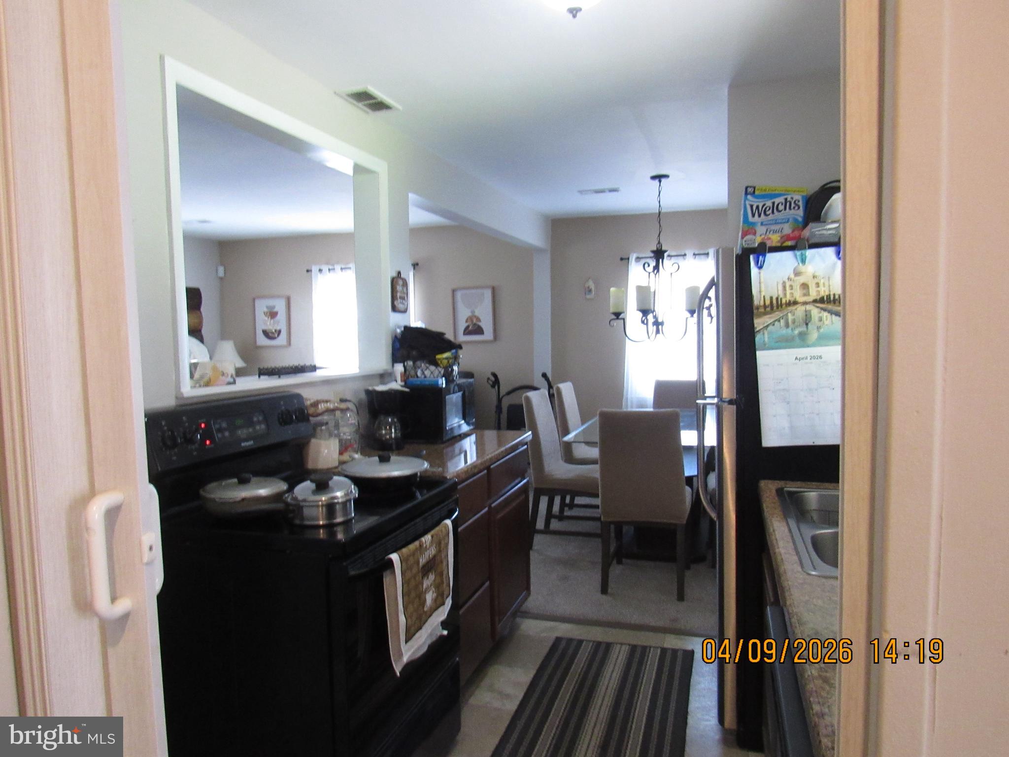 17 Lea Road New Castle, DE 19720 - Photo 7 of 17 a kitchen with granite countertop a sink stove and cabinets