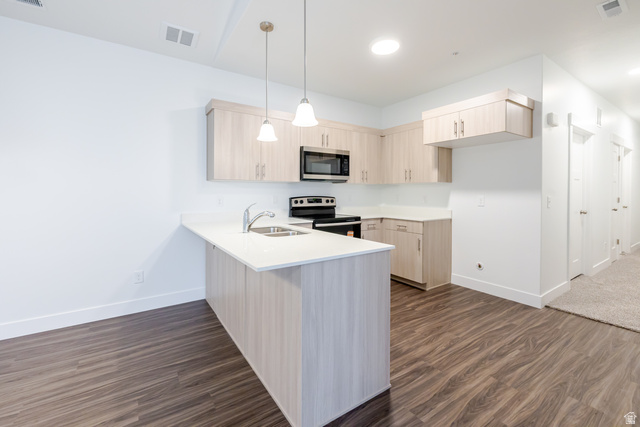 709 West 4500th South, Unit N302 Mapleton, UT 84664 - Photo 10 of 15 Kitchen featuring a peninsula, light wood finish cabinets, pendant lighting, stainless steel appliances, and dark wood-type flooring