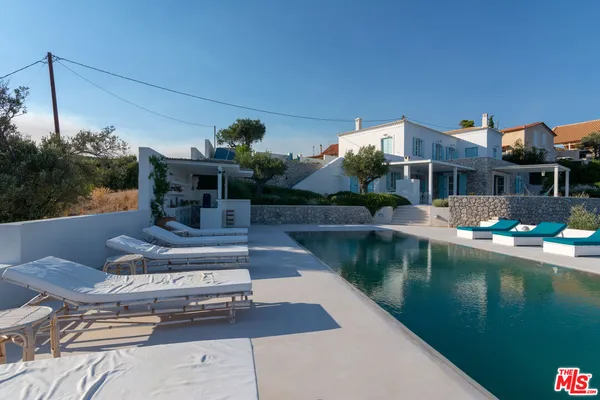 a view of house with swimming pool yard and outdoor seating