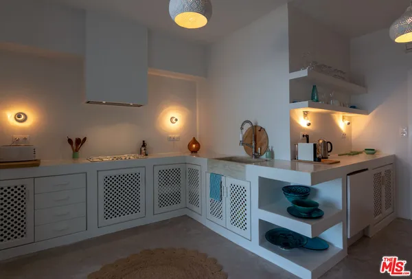 a kitchen with a sink and cabinets