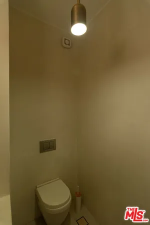 a white toilet sitting next to a shower curtain