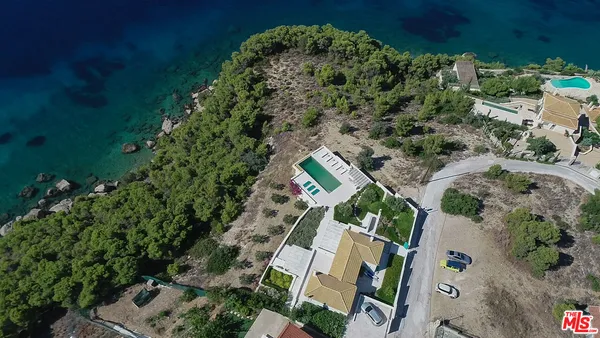 an aerial view of a house with a yard