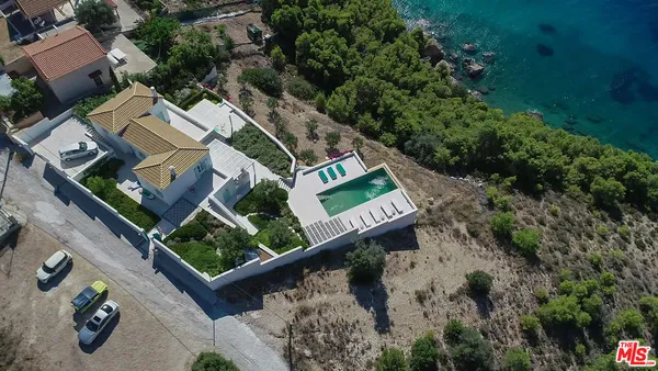 an aerial view of a house with a yard
