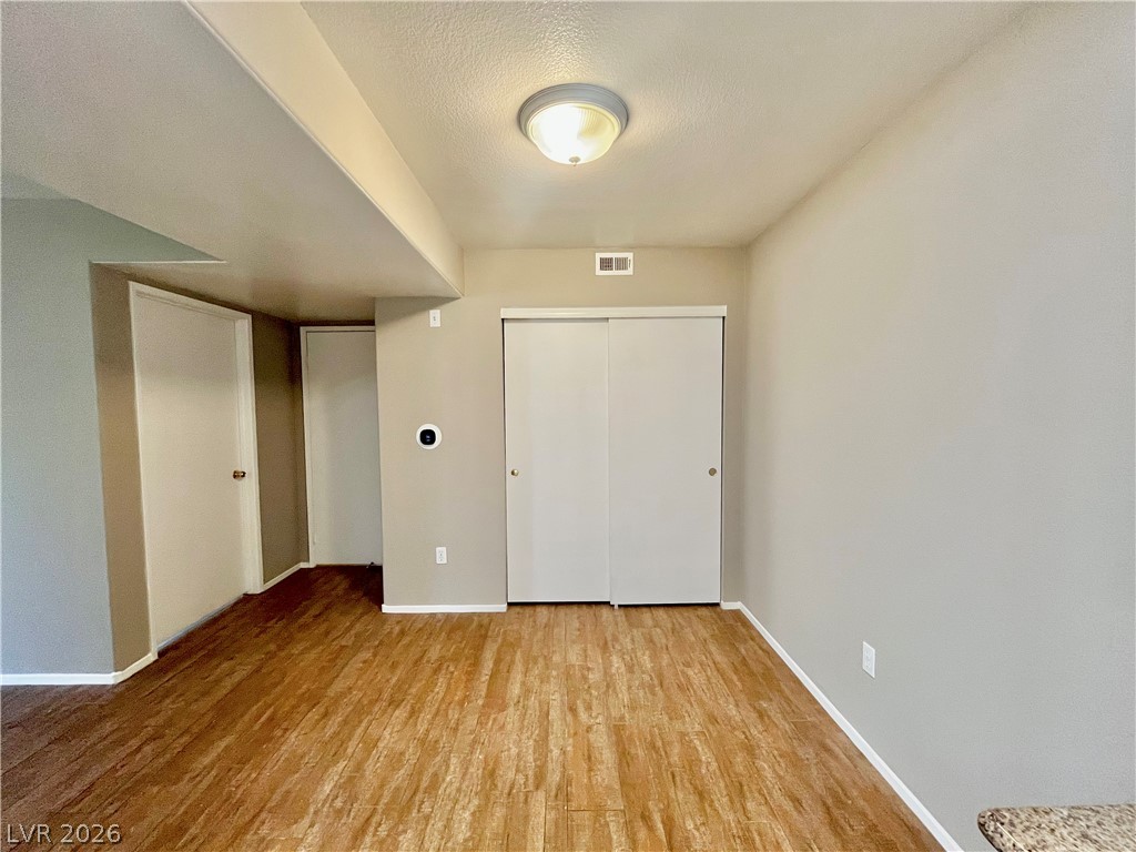 7885 West Flamingo Road, Unit 1029 Las Vegas, NV 89147 - Photo 9 of 18 An inviting room awaits with rich wood flooring and ample storage.