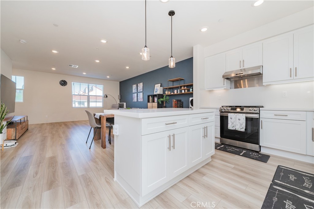 2425 Villena Way Placentia, CA 92870 - Photo 11 of 35 a kitchen with white cabinets and chairs