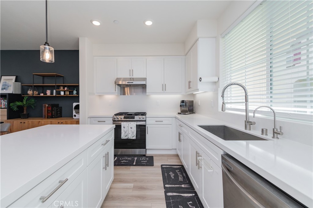 2425 Villena Way Placentia, CA 92870 - Photo 14 of 35 a kitchen with granite countertop a sink stainless steel appliances and cabinets