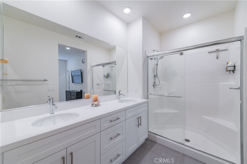 2425 Villena Way Placentia, CA 92870 - Photo 23 of 35 a bathroom with double vanity sink and shower