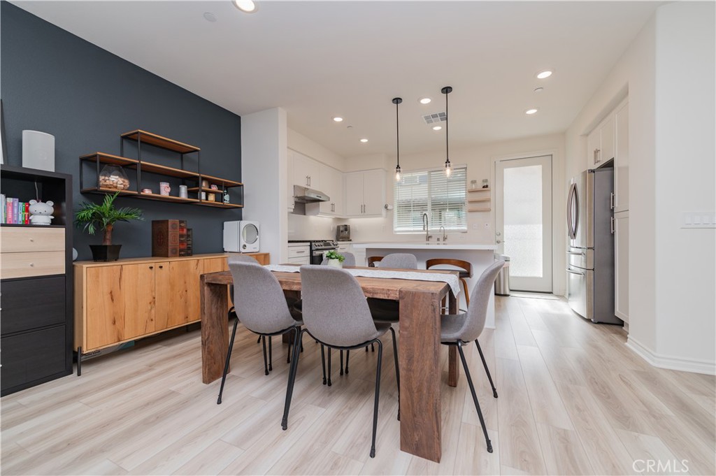 2425 Villena Way Placentia, CA 92870 - Photo 5 of 35 a view of a dining room with furniture and wooden floor