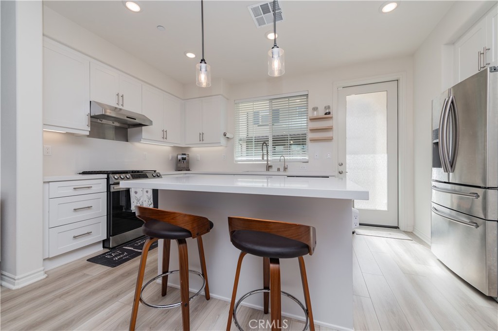2425 Villena Way Placentia, CA 92870 - Photo 6 of 35 a kitchen with cabinets a counter space stainless steel appliances and wooden floor