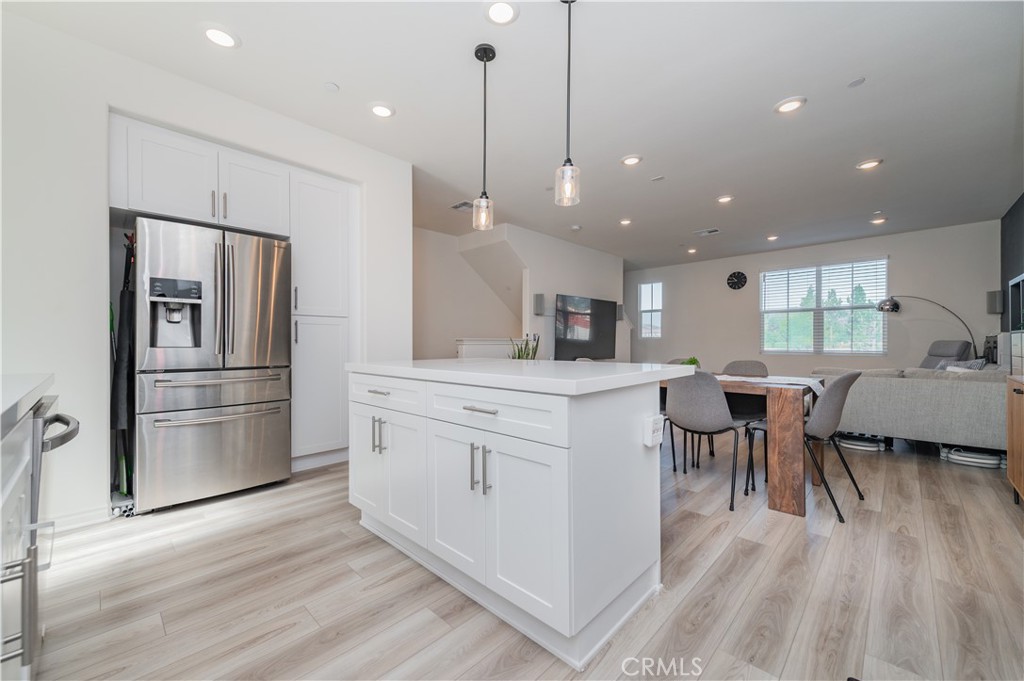 2425 Villena Way Placentia, CA 92870 - Photo 8 of 35 a kitchen with white cabinets and stainless steel appliances