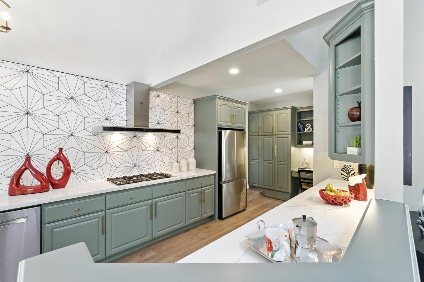 148 Promethean Way Mountain View, CA 94043 - Photo 11 of 45 a kitchen with stainless steel appliances kitchen island granite countertop a refrigerator and a sink