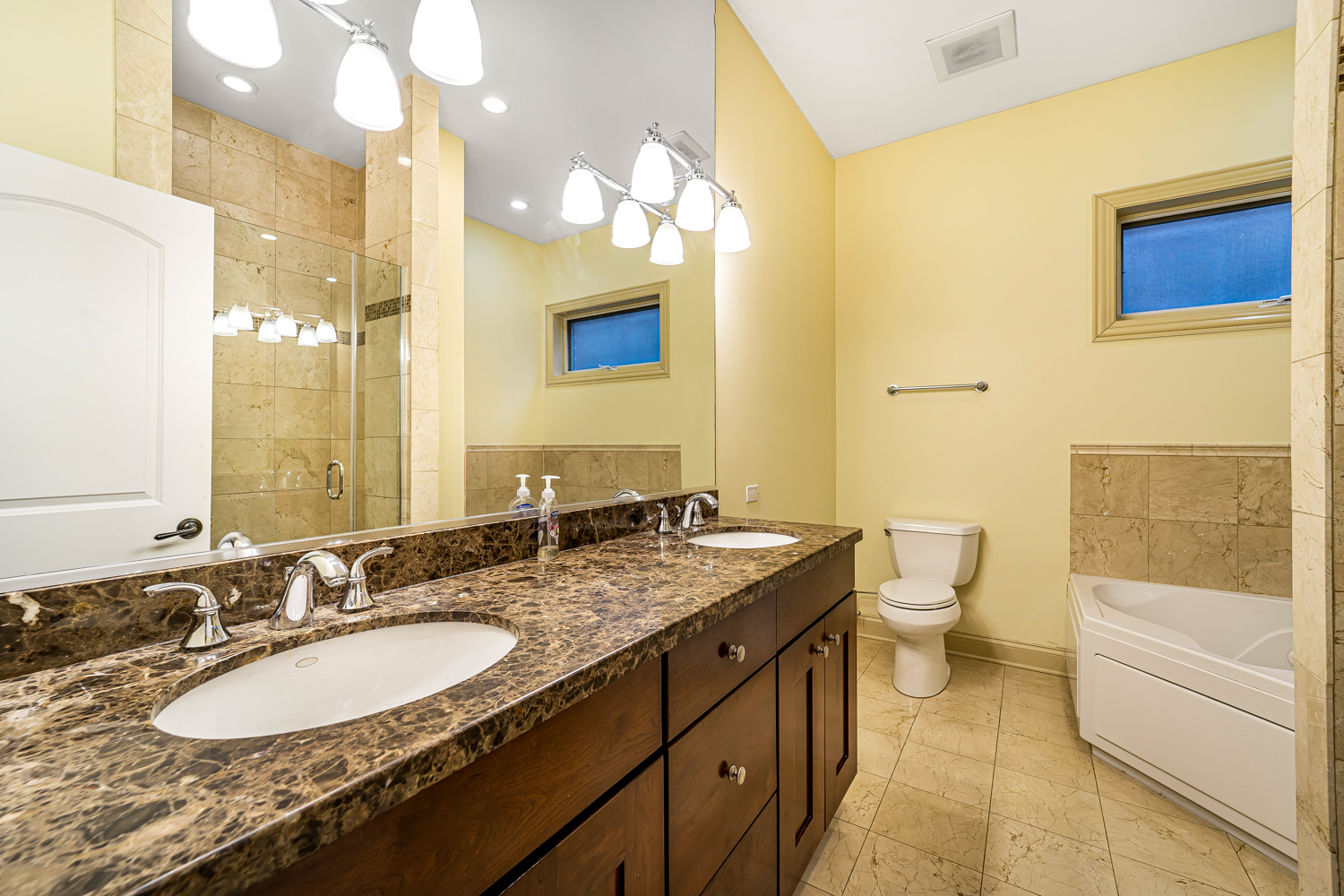 1018 South May Street, Unit F Chicago, IL 60607 - Photo 11 of 21 a bathroom with a granite countertop sink mirror vanity and toilet
