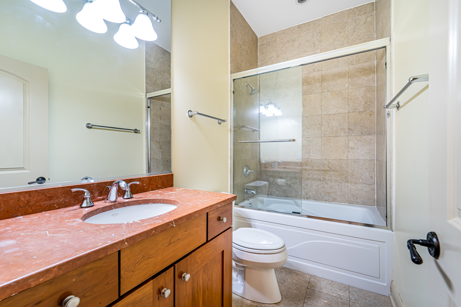 1018 South May Street, Unit F Chicago, IL 60607 - Photo 17 of 21 a bathroom with a granite countertop sink a toilet and shower