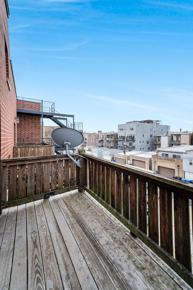 1018 South May Street, Unit F Chicago, IL 60607 - Photo 19 of 21 a balcony with wooden floor