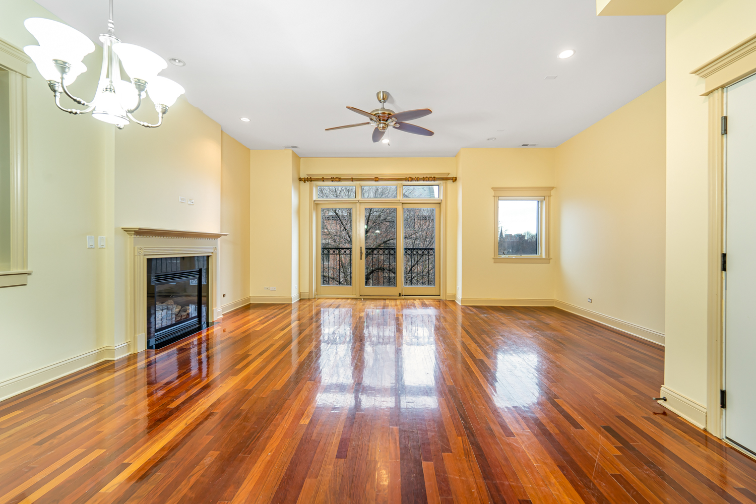 1018 South May Street, Unit F Chicago, IL 60607 - Photo 6 of 21 a view of an empty room with wooden floor and a window