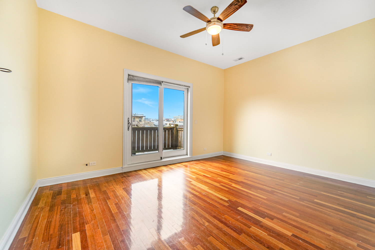 1018 South May Street, Unit F Chicago, IL 60607 - Photo 9 of 21 a view of an empty room with wooden floor and a window