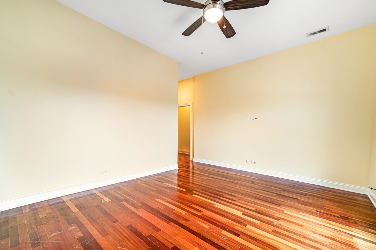 1018 South May Street, Unit F Chicago, IL 60607 - Photo 10 of 21 a view of a room with wooden floor and ceiling fan