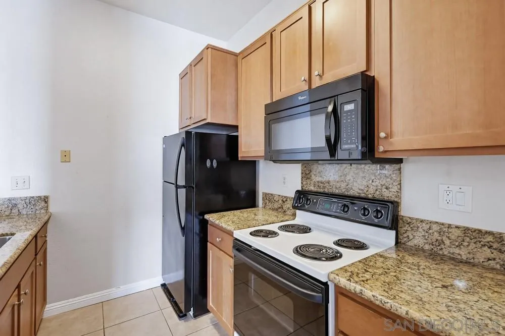 8324 Regents Road, Unit 2E San Diego, CA 92122 - Photo 11 of 31 a kitchen with a stove and a microwave