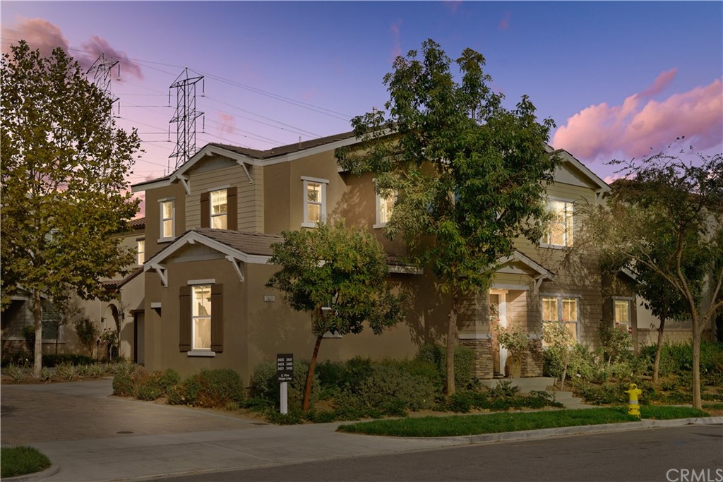 3435 Pine Ridge Loop Ontario, CA 91761 - Photo 1 of 1 a front view of a house with a yard and tree s