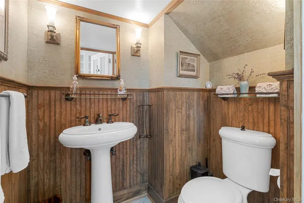 a bathroom with a sink mirror toilet and shower