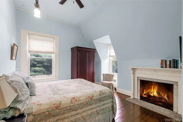 a bedroom with a bed and a fireplace