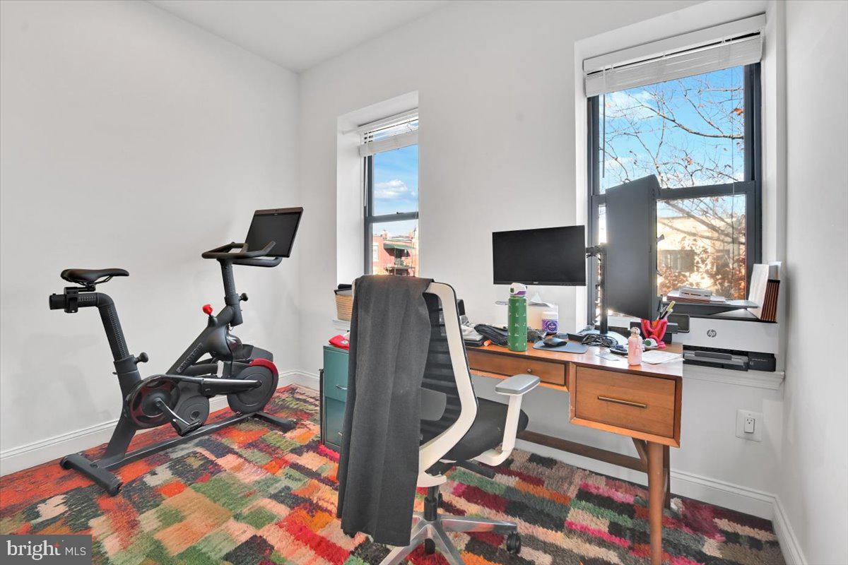 1614 15th Street Northwest Washington, DC 20009 - Photo 15 of 47 a room with furniture a flat screen tv and a window