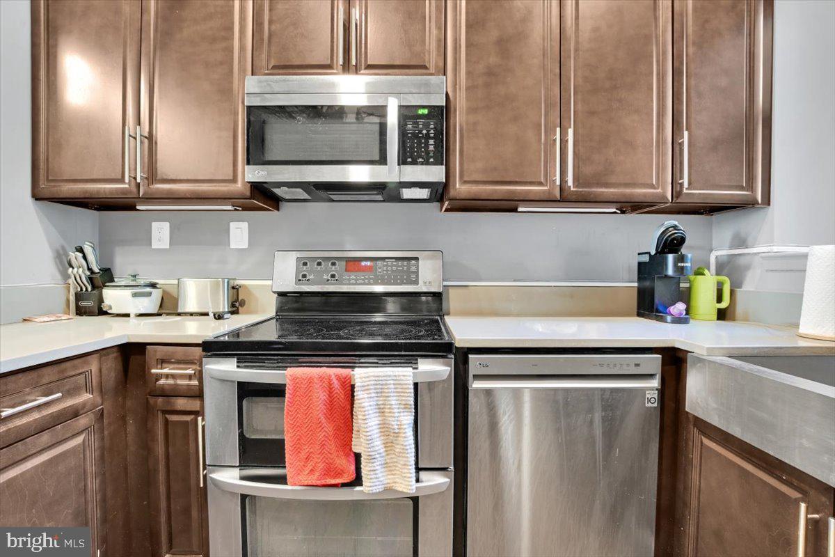 1614 15th Street Northwest Washington, DC 20009 - Photo 24 of 47 a kitchen with stainless steel appliances granite countertop a stove and a microwave