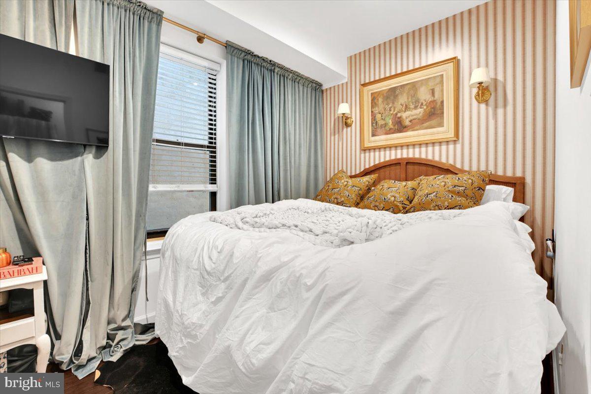 1614 15th Street Northwest Washington, DC 20009 - Photo 38 of 47 a bedroom with a bed flat screen tv and a window