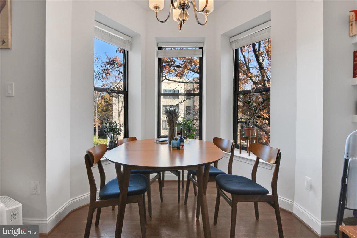 1614 15th Street Northwest Washington, DC 20009 - Photo 9 of 47 a dining room with furniture a rug and a window