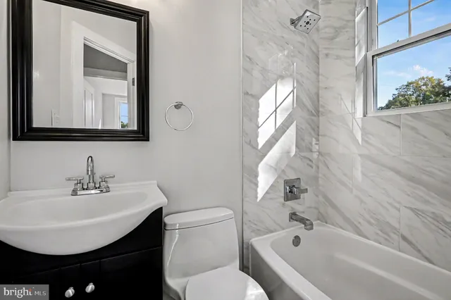 a bathroom with a sink a toilet and a bathtub