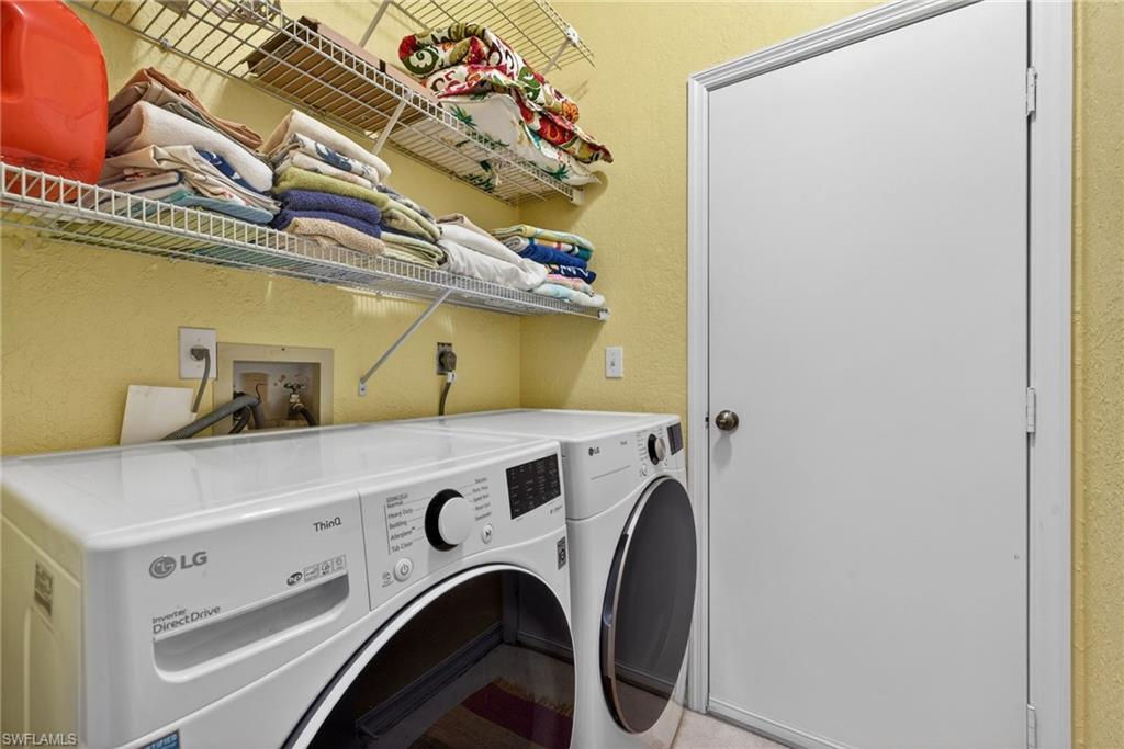290 Emerald Bay Circle, Unit L7 Naples, FL 34110 - Photo 14 of 22 a utility room with dryer and washer