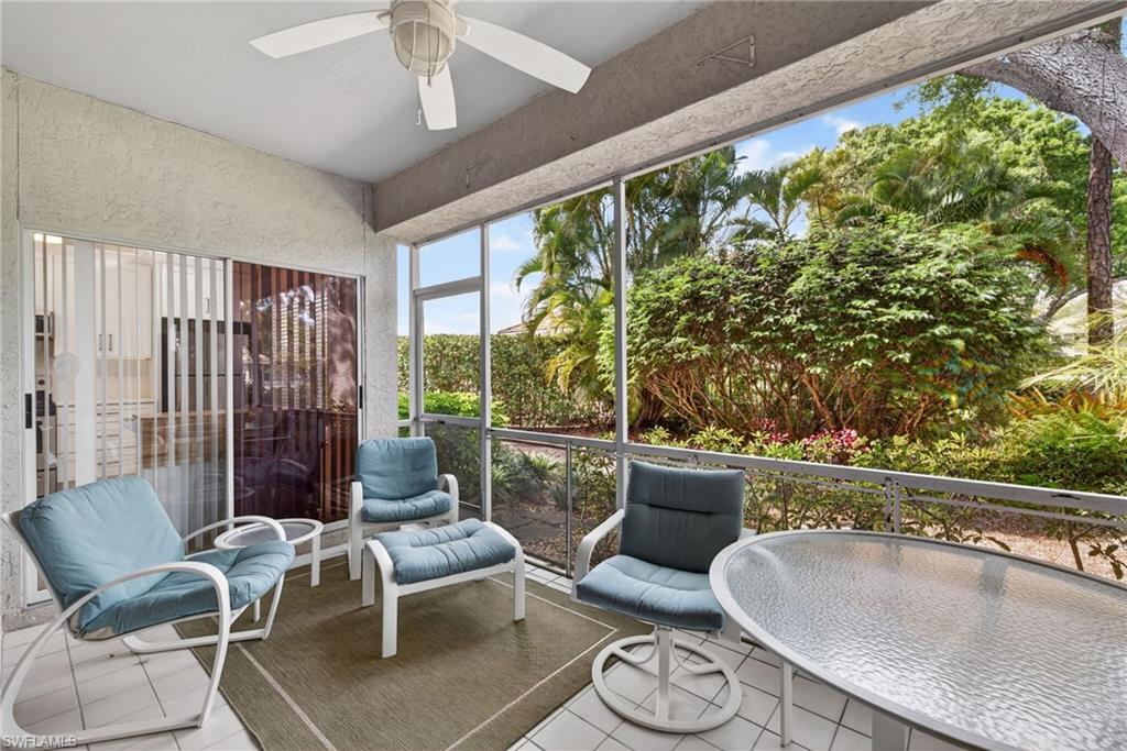 290 Emerald Bay Circle, Unit L7 Naples, FL 34110 - Photo 16 of 22 a living room with furniture and a large window