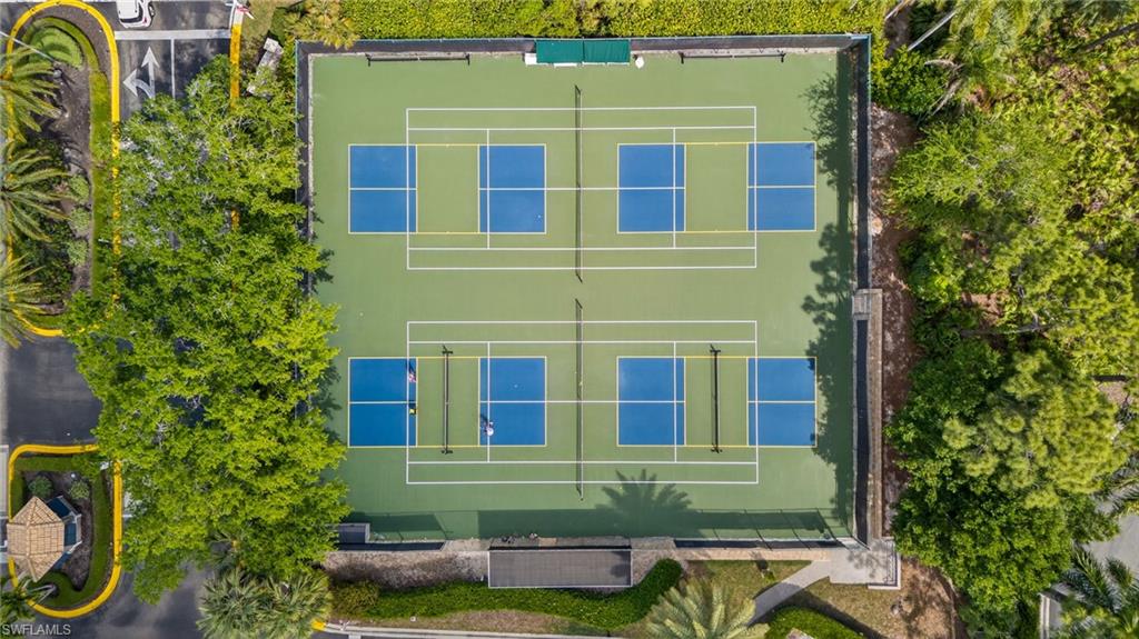 290 Emerald Bay Circle, Unit L7 Naples, FL 34110 - Photo 20 of 22 a front view of a house with a yard