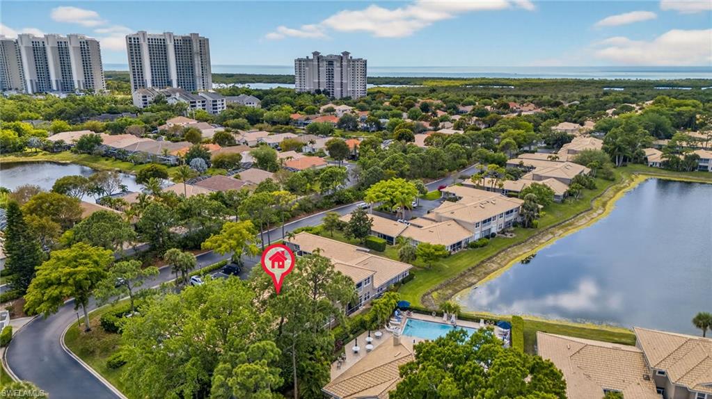 290 Emerald Bay Circle, Unit L7 Naples, FL 34110 - Photo 22 of 22 an aerial view of residential houses with outdoor space and trees