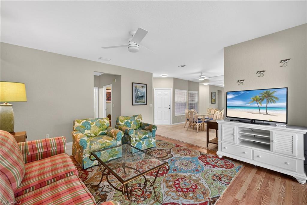 290 Emerald Bay Circle, Unit L7 Naples, FL 34110 - Photo 9 of 22 a living room with furniture and a flat screen tv