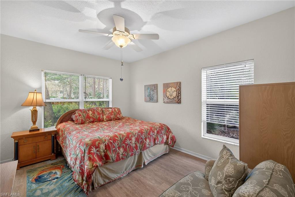 290 Emerald Bay Circle, Unit L7 Naples, FL 34110 - Photo 10 of 22 a bedroom with a bed and window