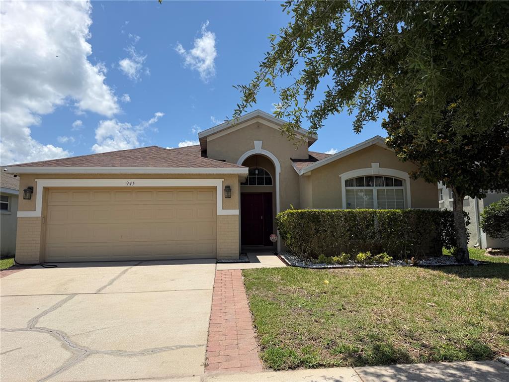 945 Tramells Trail Kissimmee, FL 34744 - Photo 3 of 36 a front view of a house with a yard