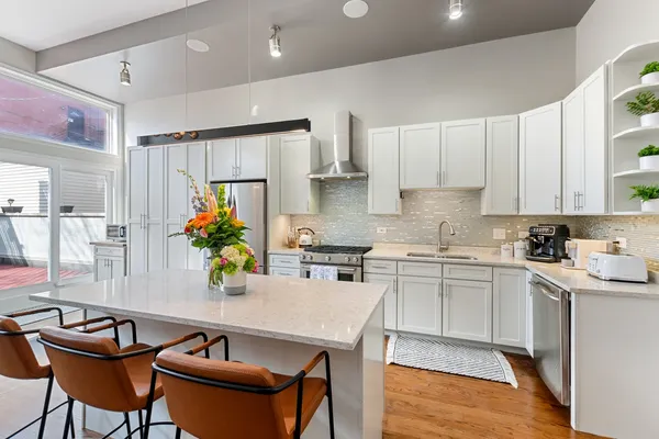 a kitchen with stainless steel appliances granite countertop sink stove top oven and microwave