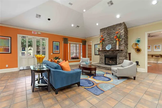 a living room with furniture a fireplace and a flat screen tv