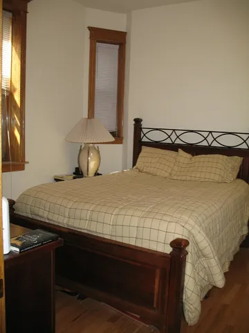 a bedroom with a bed and a mirror