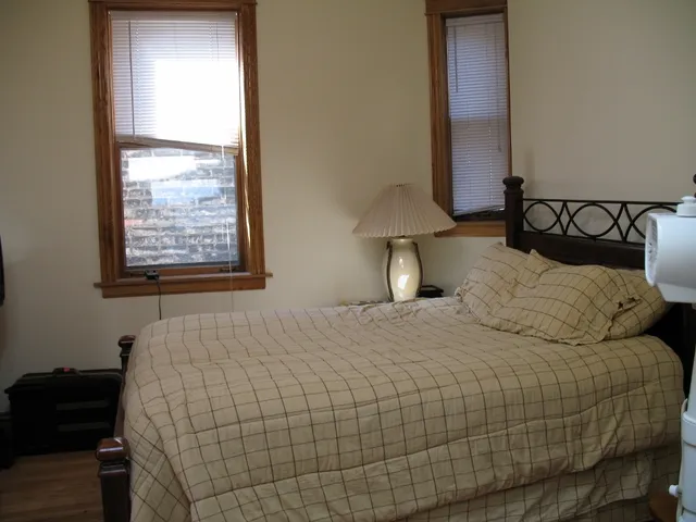 a bedroom with a bed and a window