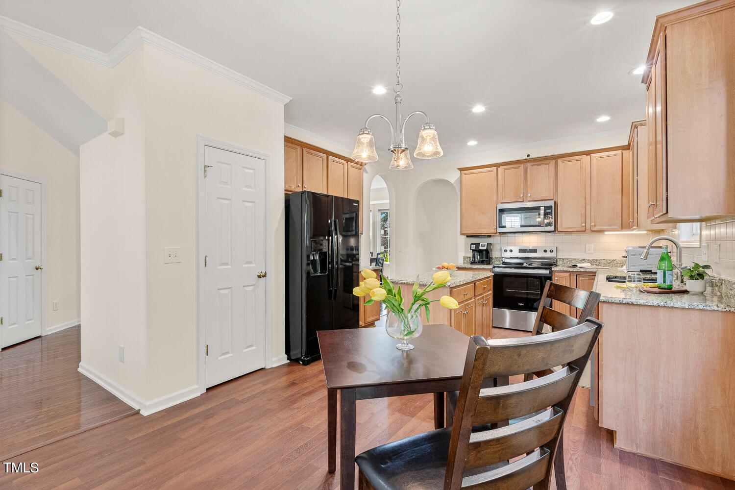 2013 Prairie Ridge Court Fuquay-Varina, NC 27526 - Photo 11 of 53 a kitchen with a dining table chairs and refrigerator