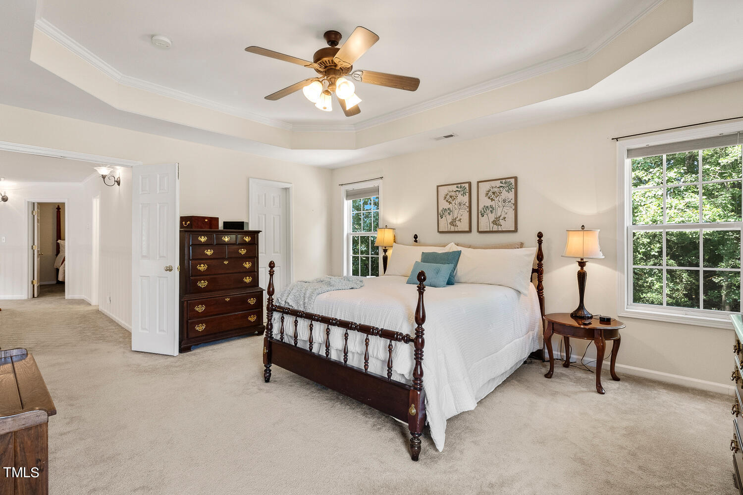 2013 Prairie Ridge Court Fuquay-Varina, NC 27526 - Photo 27 of 53 a spacious bedroom with a bed a table and a chandelier