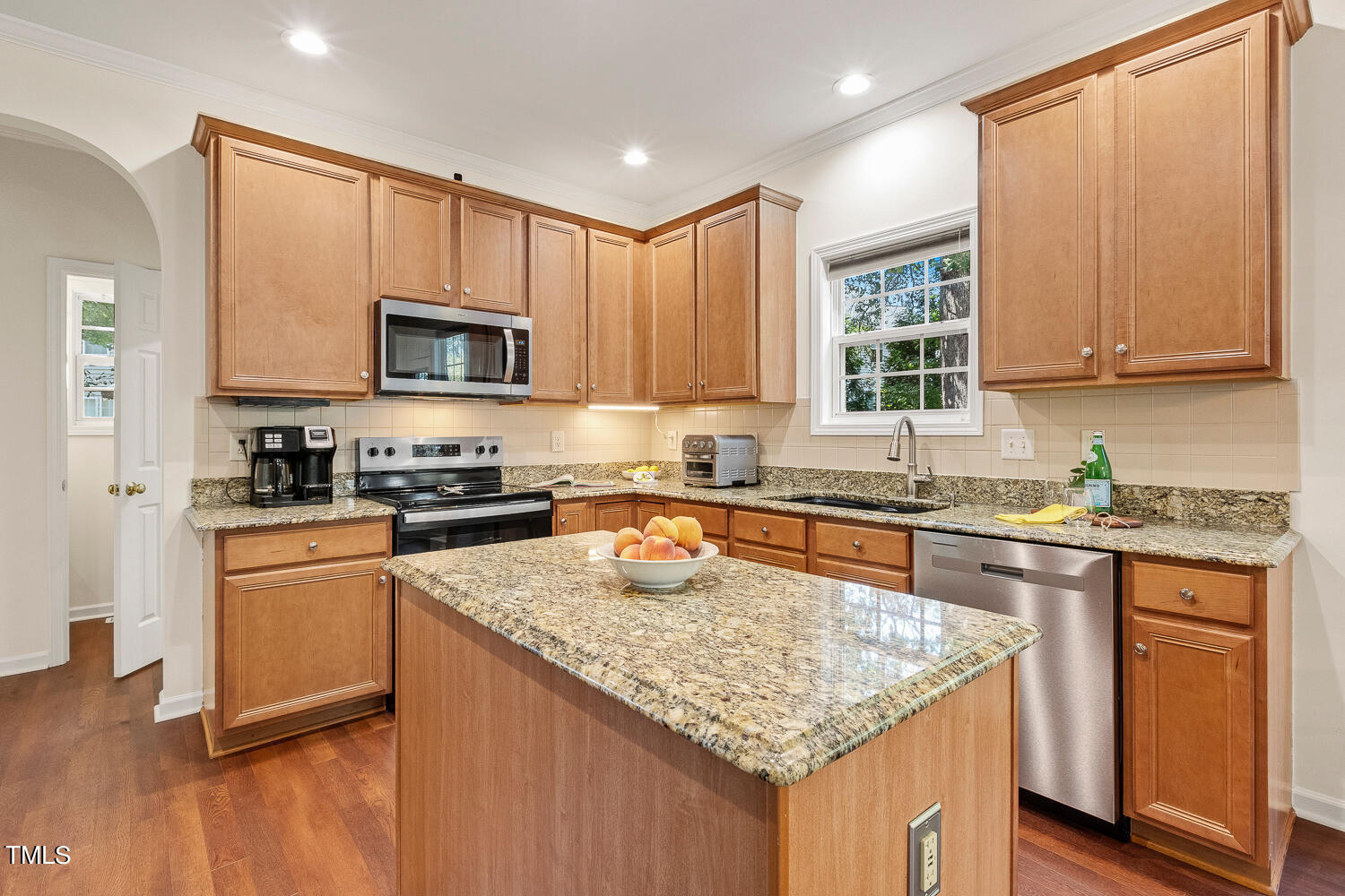 2013 Prairie Ridge Court Fuquay-Varina, NC 27526 - Photo 6 of 53 a kitchen with granite countertop a sink stove and cabinets