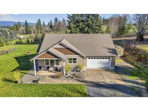 a aerial view of a house with table and chairs