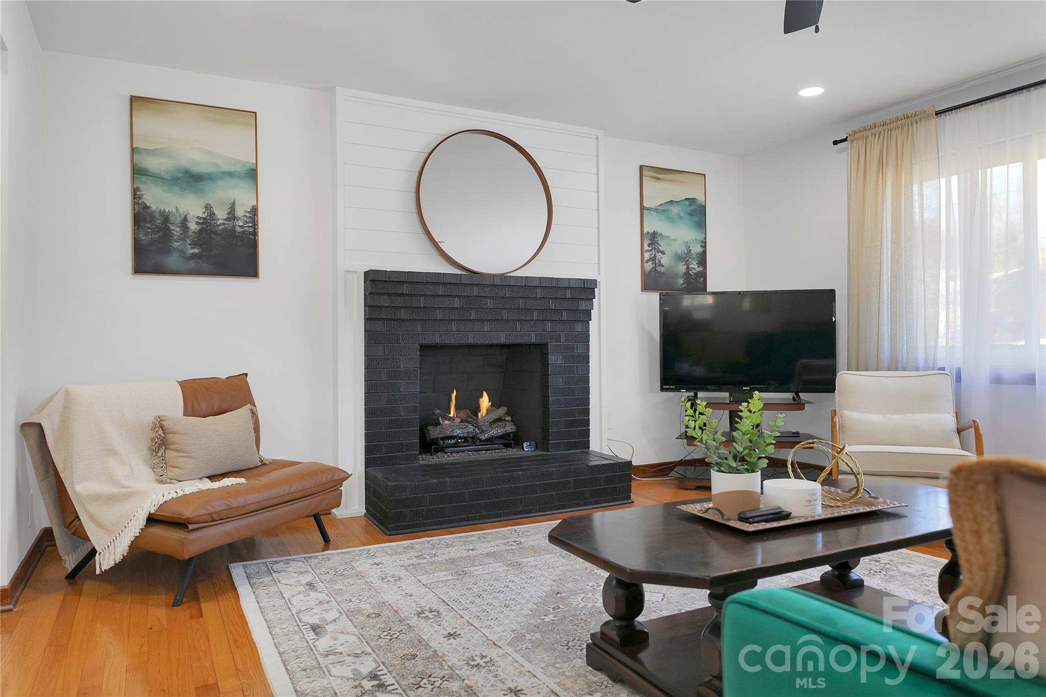 112 Allison Road Brevard, NC 28712 - Photo 1 of 37 a living room with furniture a flat screen tv and a fireplace